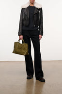 Black leather jacket with plush shearling collar, front zipper, and flap chest pockets