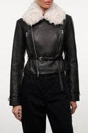 Black leather jacket with shearling collar, asymmetrical zip front, and belted waist