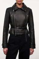 Black leather jacket with stand collar, asymmetrical zippers, and tie-belt waist