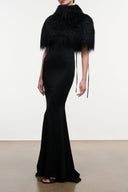 Black faux-fur shrug with fringe and draped shoulder fit over dress