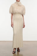 Ivory fringe shrug with high neck and short sleeves, layered over a knit dress