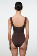 Dark one-piece swimsuit with scoop back, thin straps, and center back closure