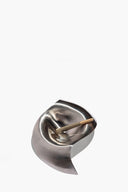 Silver metal ashtray with cigarette rest slot and pointed base