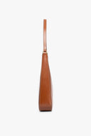 Tan leather-look hobo bag with top handle, side view