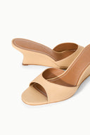Tan wedge sandals with stitched upper, open toe, and low heel