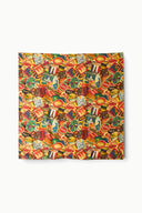Silk scarf with colorful travel-themed print in reds, oranges, greens, and yellows