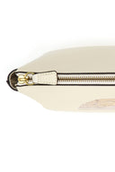 Cream pouch detail with gold-tone zipper, leather tab, and strap