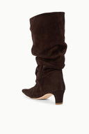 Brown suede slouch boots with gathered front and low block heel, angled view