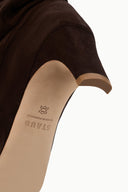Brown suede slouch boot interior view with logo on insole and low heel