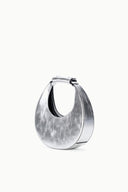 Silver crescent bag with side handle and open top, inner lining visible
