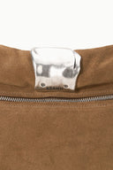 Silver cuff hardware with STAUD logo on Husk brown clutch flap