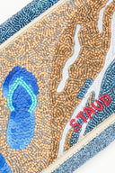 Beaded mosaic design with blue, orange, and white colors on a rectangular background