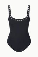 Black one-piece swimsuit flat lay with scoop neck and silver eyelet trim straps