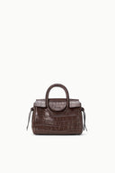 Mini carryall handbag, croc-embossed espresso brown with front strap and tassels.