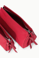 Red zip pouches with bow-tie pulls and interior zipper close-up