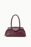 Dark burgundy structured shoulder bag with top handles and tucked side detail