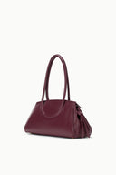 Dark burgundy structured leather shoulder bag with top handles and side bow detail