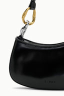 Black handbag with a gold and silver clasp on a white background