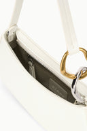 Off-white hobo bag interior view with zippered opening and fabric lining.