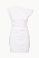 White mini dress close-up showing gathered waist and ruched bodice