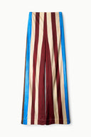 Striped silk pants with maroon, cream, and blue vertical stripes