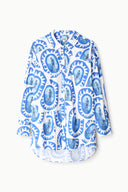 Blue-and-white patterned button-front top with long sleeves and cuffs, front view