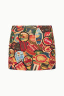 Flat lay of printed mini skirt with multicolor travel-map pattern and elastic waistband