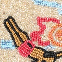 Beaded applique with colorful figures and black stitched outline on gold sparkle fabric