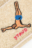 Beaded flap detail with guitar, colorful figures, and pink circular bead embellishment