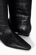Black croc-embossed boot upper and pointed toe with low stacked heel