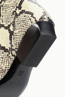 Snake-print flat boot heel and side tab detail with black rubber sole