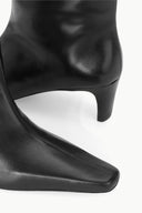 Black leather western boot showing curved toe and low block heel