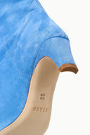 Light blue suede boot shaft with tan pull tab and star logo on lining