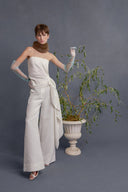 Ivory draped sleeveless top with wrap-style side tie