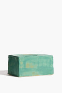Teal glazed ceramic tissue box, side view with open top slot