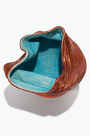 Sunken vase with open top showing turquoise interior and dark brown outer rim