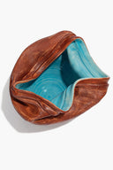 Sunken vase angled view with turquoise interior and ridged dark brown exterior
