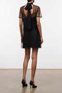 Black patterned mini dress with open back and black neck tie bow