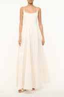 Ivory maxi dress with spaghetti straps and scoop neckline, fitted bodice and flowing skirt