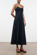 Black sleeveless dress with scalloped neckline, spaghetti straps, gathered bodice and skirt