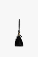Black Kaia top-handle bag with zipper closure and gold hardware